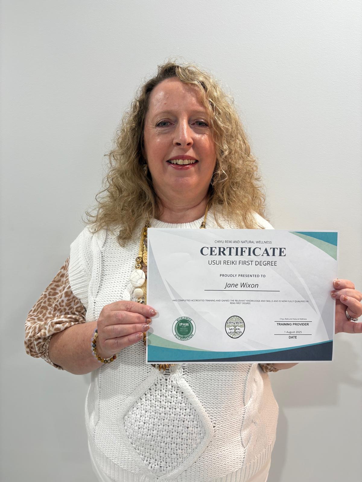 Student proudly holding her Usui Reiki First Degree certificate